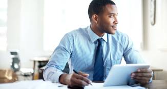 Online MHA student at desk